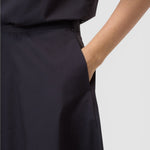 JONES + CO black midi skirt featuring a side pocket and discreet side-seam zip closure.