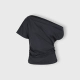 JONES + CO black one-shoulder Mata top in organic crisp cotton with an asymmetric neckline and fluid drape.