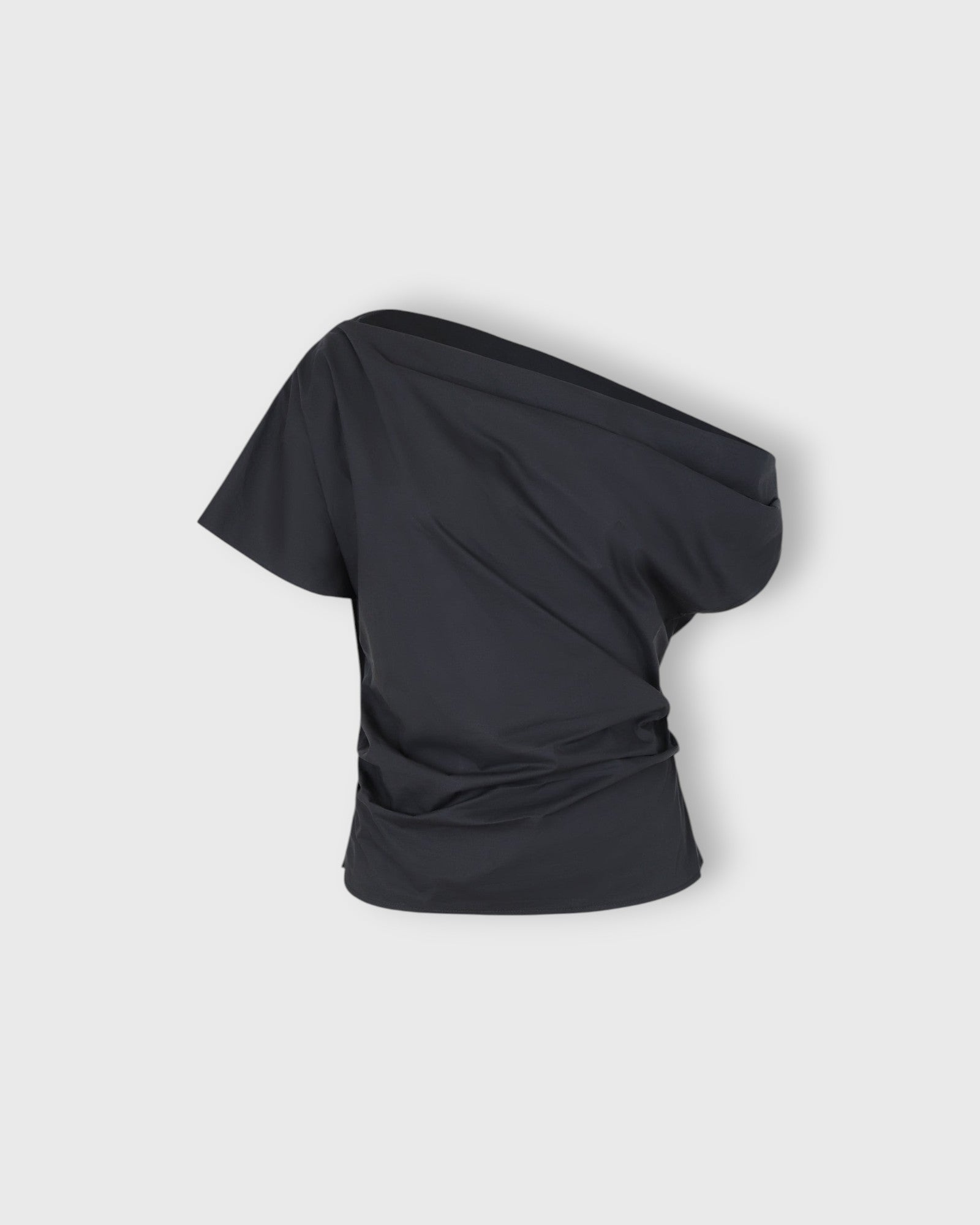 JONES + CO black one-shoulder Mata top in organic crisp cotton with an asymmetric neckline and fluid drape.