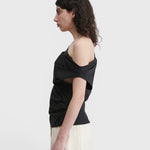 JONES + CO black one-shoulder Mata top in organic crisp cotton with an asymmetric neckline and short sleeve