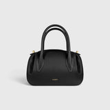 JONES + CO Oyster mini duffle bag in black pebble grained leather with gold-tone hardware and structured top handles.