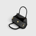 JONES + CO Oyster mini duffle bag in black pebble grained Italian leather with gold-tone hardware and top handles.