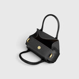 JONES + CO Oyster mini duffle bag in black pebble grained Italian leather with gold-tone hardware and top handles.