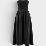JONES + CO black strapless midi dress with a smocked bodice and relaxed skirt in stretch-cotton fabric.