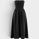 JONES + CO black strapless midi dress with a smocked bodice and relaxed skirt in stretch-cotton fabric.