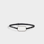 JONES + CO black crust leather belt with an oversized oval buckle and polished metal rivets along the slim strap.