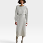 Model wearing JONES + CO black leather Studded Cole Belt with oversized oval buckle over a grey knit midi dress