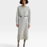 Model wearing JONES + CO black leather Studded Cole Belt with oversized oval buckle over a grey knit midi dress