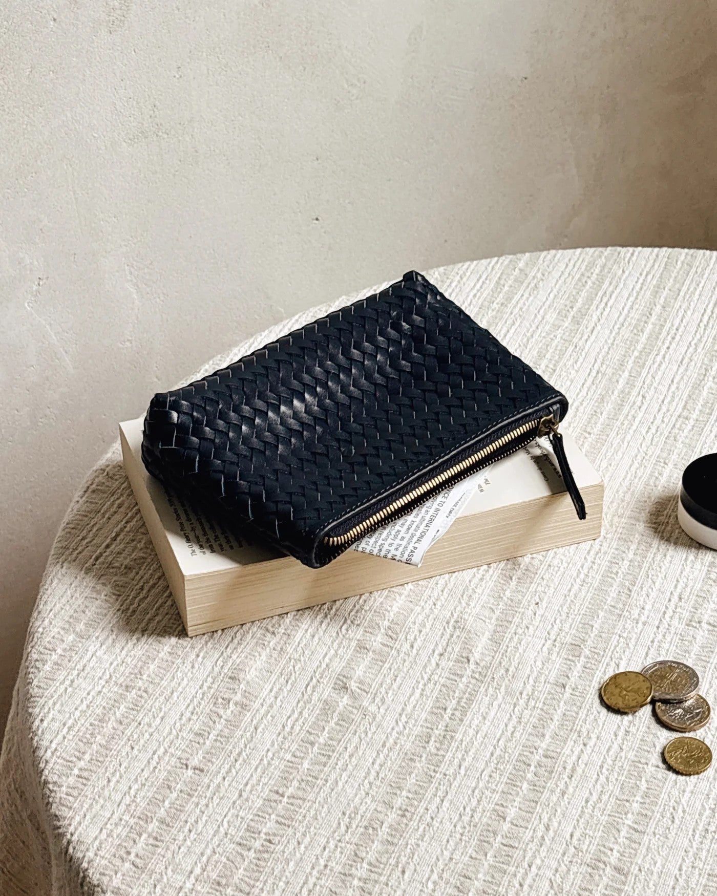 JONES + CO black woven leather Cleo Pouch with zip closure, perfect for organizing essentials.