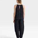 JONES + CO black Lyocell blend balloon-leg trousers with wrinkle finish and ankle button detail.