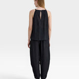JONES + CO black Lyocell blend balloon-leg trousers with wrinkle finish and ankle button detail.