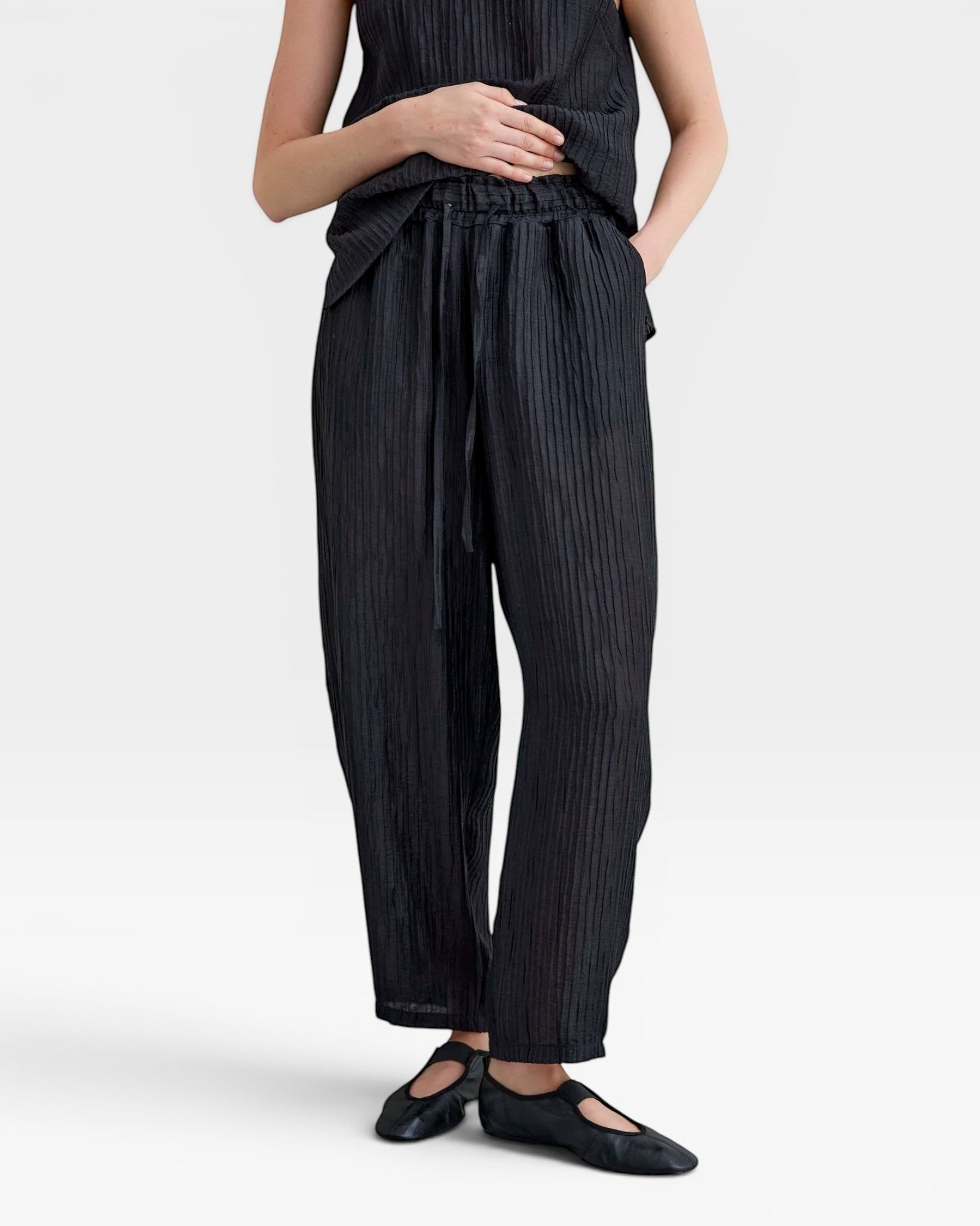 JONES + CO black Lyocell blend balloon-leg trousers with elasticated waistband and adjustable drawstrings.