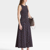 JONES + CO women's sleeveless maxi dress with block print polka dot pattern and smocked bodice in navy, red, and blue.