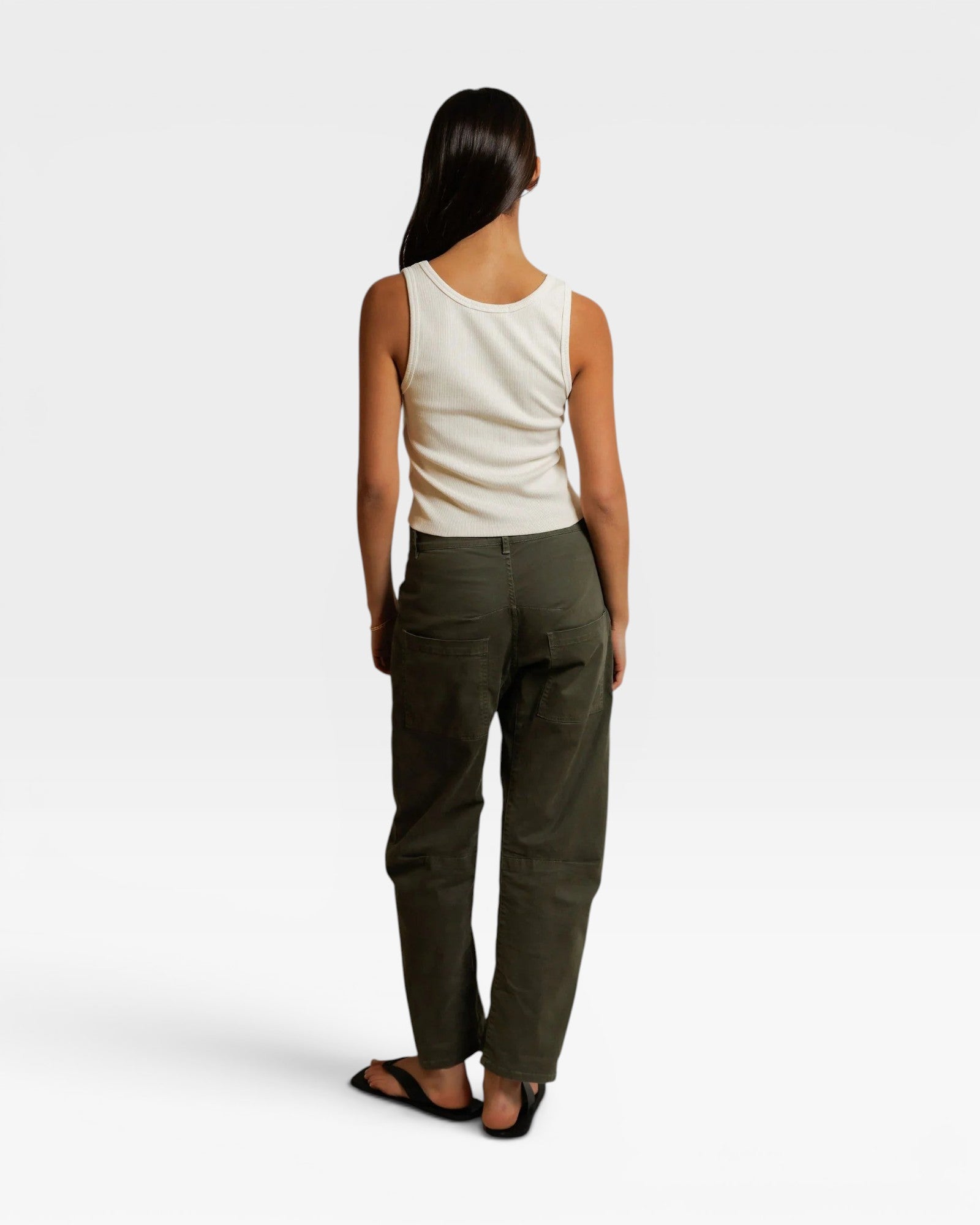 JONES + CO Blondie bright ivory ribbed tank top worn with olive green trousers, back view