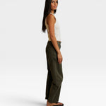 JONES + CO Blondie bright ivory ribbed tank top worn by a model in profile with olive green pants and sandals.