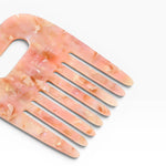 JONES + CO No. 4 Comb in Blossom, a wide-tooth comb handmade from Italian acetate with a marbled pink and gold finish.