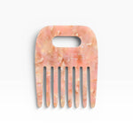 JONES + CO No. 4 Comb in Blossom, a wide-tooth comb handmade from Italian acetate in a marbled pink and gold pattern.