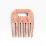 JONES + CO No. 4 Comb in Blossom, a wide-tooth comb handmade from Italian acetate in a marbled pink and gold pattern.