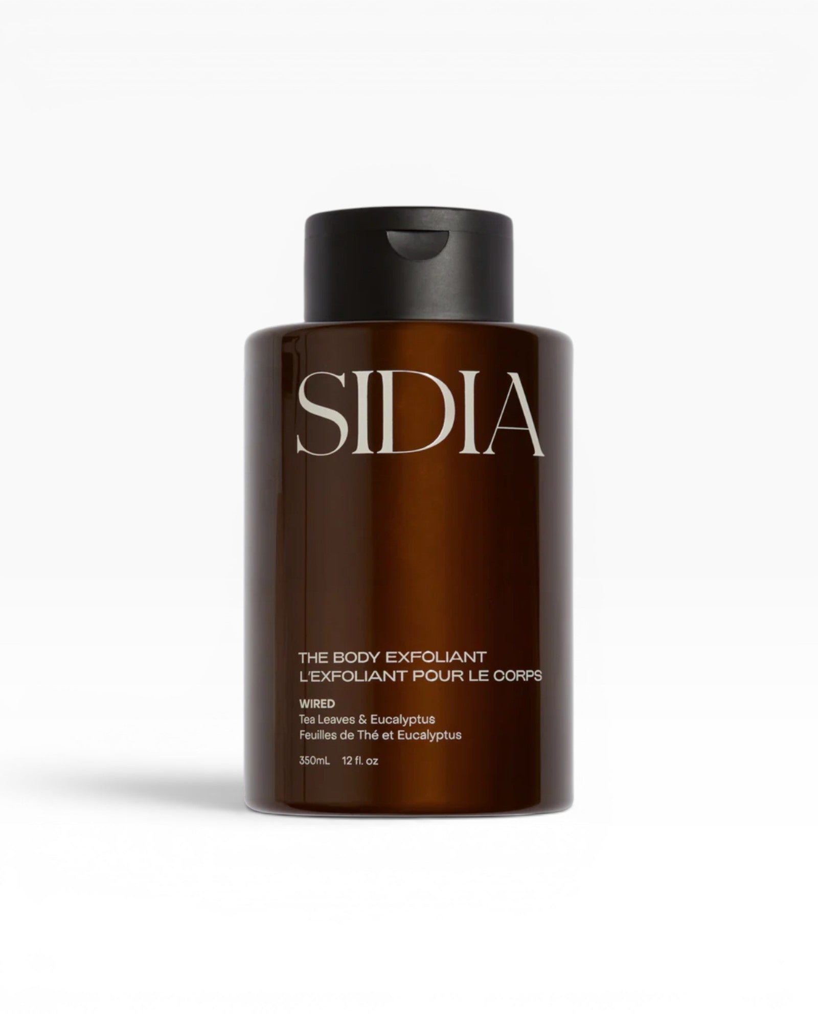 JONES + CO The Body Exfoliant WIRED in amber bottle with black pump top. Tea Leaves & Eucalyptus scent.
