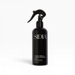JONES + CO The Body Serum BRALESS in a black spray bottle with a black trigger. Amber & Guaiac Wood scent.