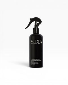 JONES + CO The Body Serum BRALESS in a black spray bottle with a black trigger. Amber & Guaiac Wood scent.