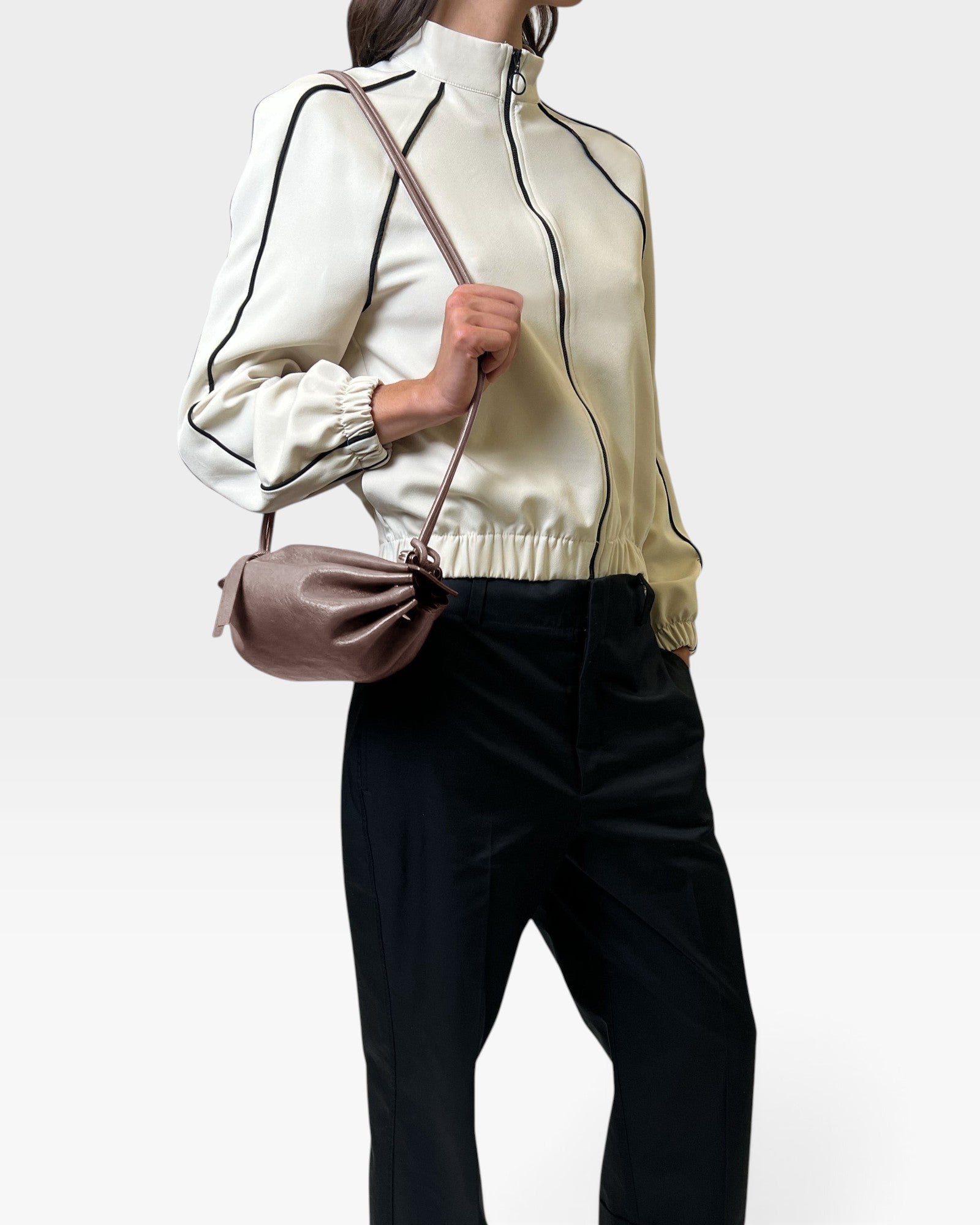 JONES + CO Bon-Bon Cords bag in shiny taupe Italian leather with a pleated design and slim cord shoulder strap.