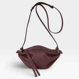 JONES + CO Bon-Bon wine-colored calf leather shoulder bag with pleated ends and palladium-finished brass hardware.