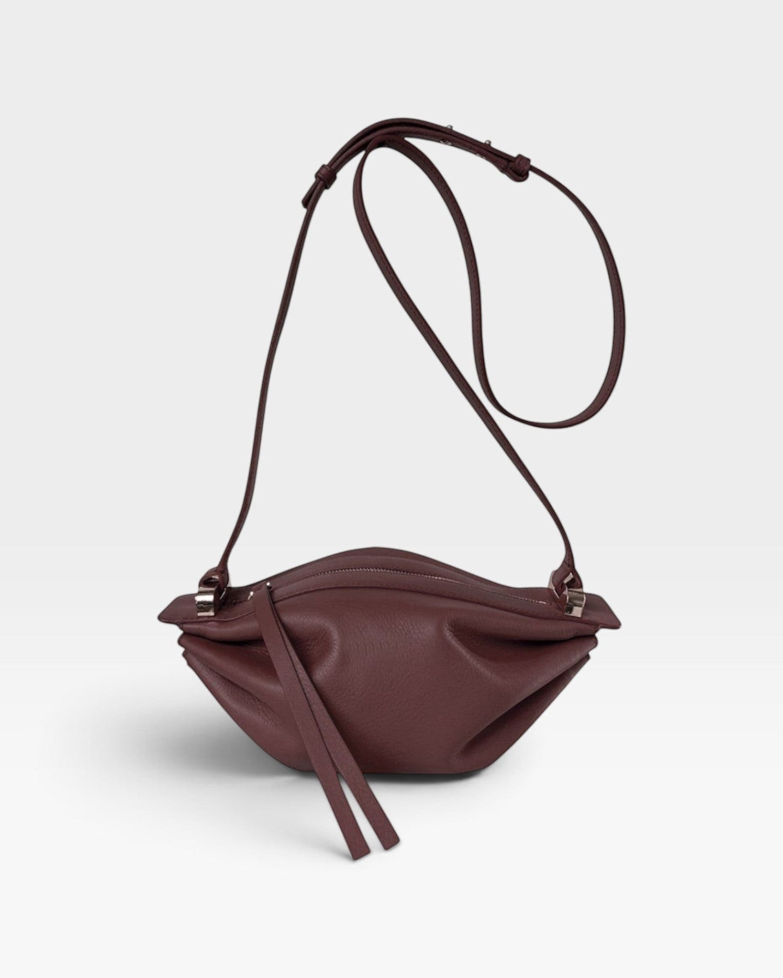 JONES + CO Bon-Bon wine-colored calf leather shoulder bag with pleated ends and palladium-finished brass hardware.