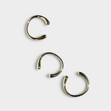 JONES + CO set of three minimalist polished brass cuff bracelets with a smooth, open-ended design.