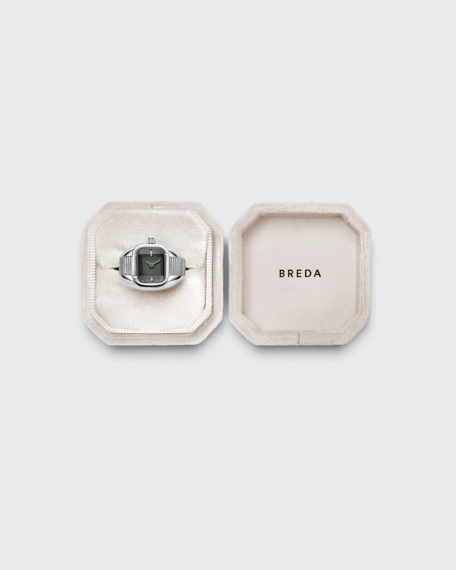 JONES + CO BREDA Nocturne Time Ring in silver stainless steel with a smoke-colored crystal in a velvet jewelry box.