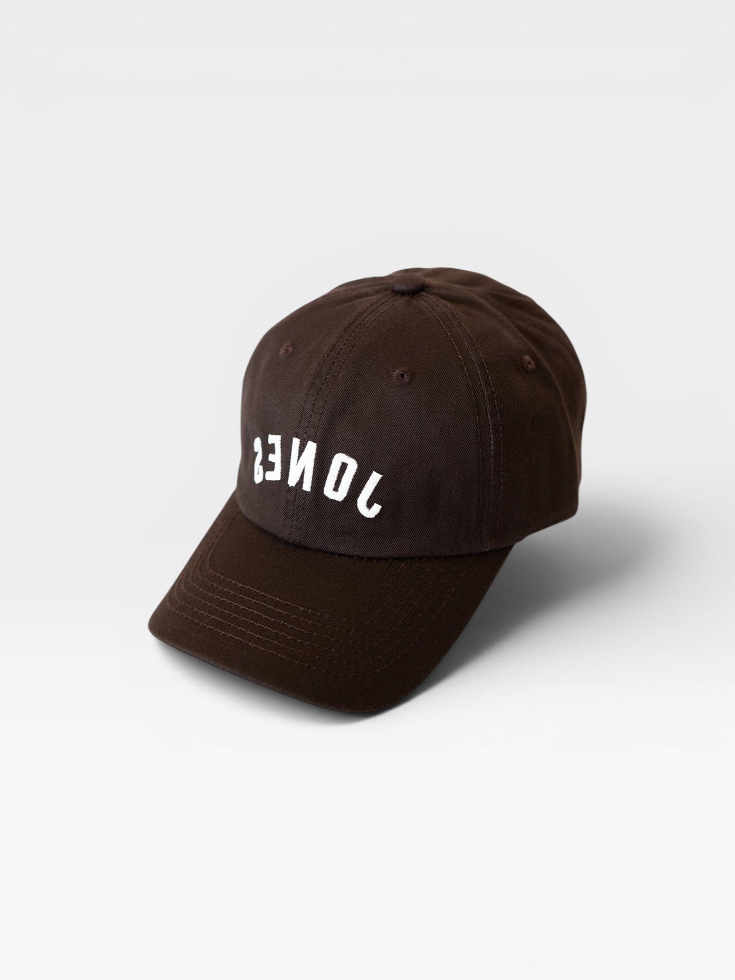 JONES + CO brown baseball cap with white inverted text embroidery on the front panel