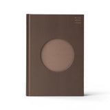 JONES + CO brown lined Open Journal with a circular cutout on the textured hard cover