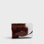 JONES + CO brown and white cowhide cardholder with a solid brass fastener, perfect for cards and cash.