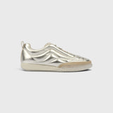 JONES + CO Bubble Ollo sneaker in metallic champagne lambskin leather with a suede toe and translucent foam sole.