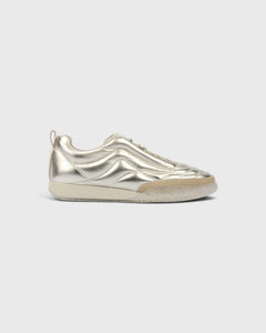JONES + CO Bubble Ollo sneaker in metallic champagne lambskin leather with a suede toe and translucent foam sole.