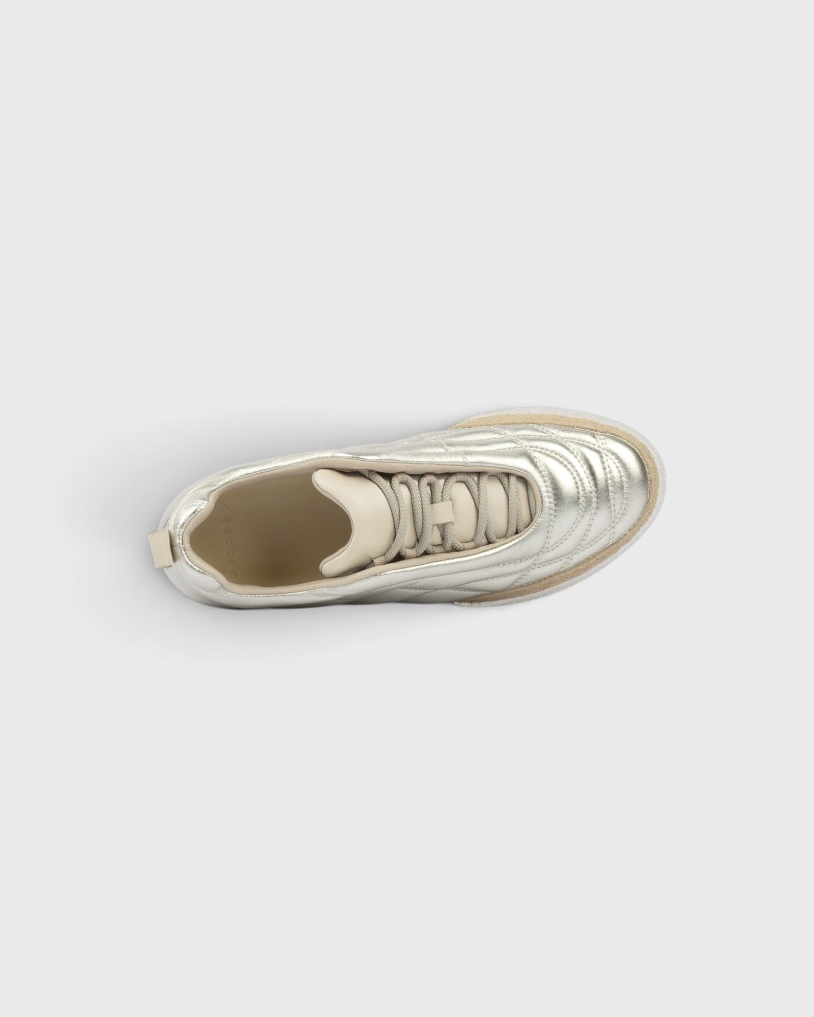 JONES + CO Bubble Ollo sneaker in metallic champagne lambskin leather with a suede toe and translucent bubble sole.