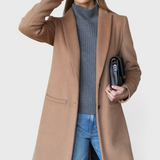 JONES + CO camel wool cashmere tailored coat with notch collar worn by a model with a grey sweater and blue jeans