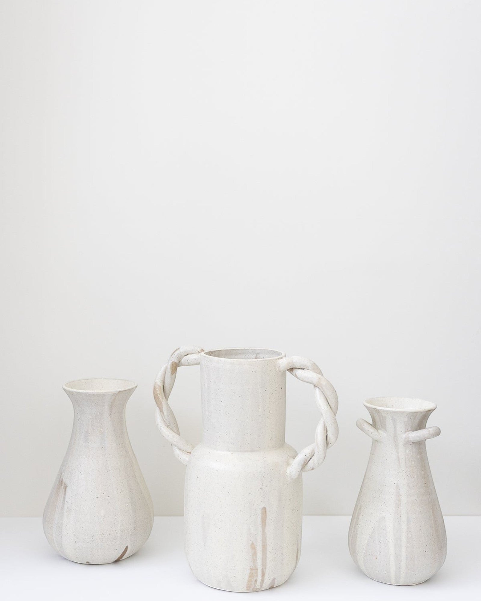 JONES + CO cream speckled ceramic bulb vase with twisted handles, handmade by Bettina Chow.