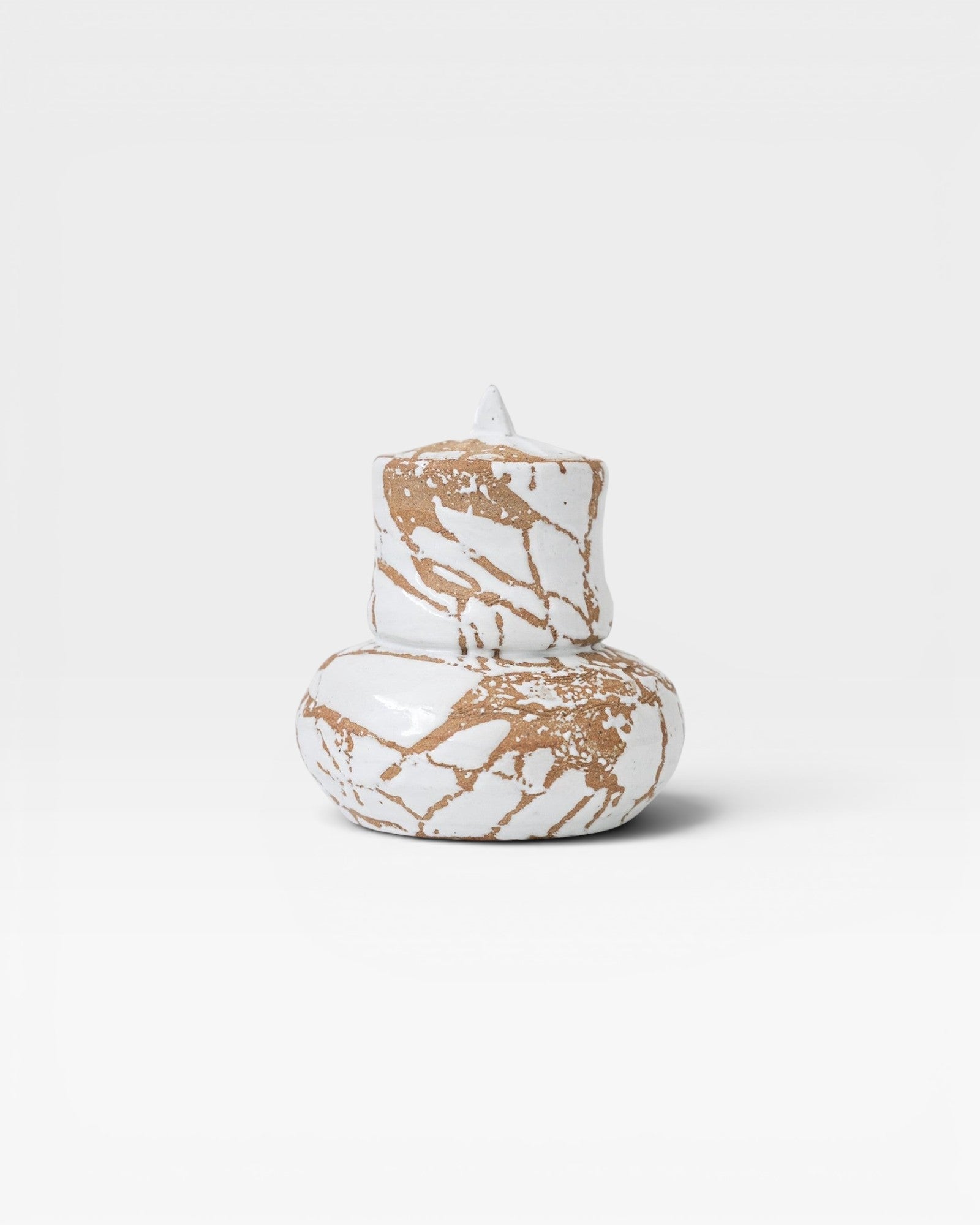JONES + CO handmade white ceramic vase with lid, featuring organic modern design and expressive glaze with brown accents.