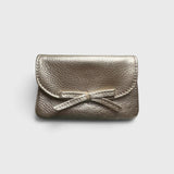 JONES + CO champagne metallic leather petite case featuring a delicate knotted bow on the front flap.