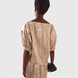 JONES + CO Filly Top in champagne shimmery textured silk with a boat neckline and puff sleeves, rear view.