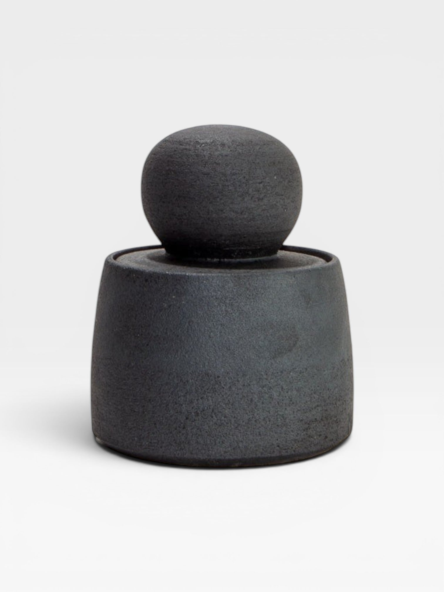JONES + CO matte charcoal stoneware stash jar with a large chunky knob and glossy black interior. Hand-thrown, unique piece.