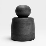 JONES + CO matte charcoal stoneware stash jar with a large chunky knob and glossy black interior. Hand-thrown, unique piece.