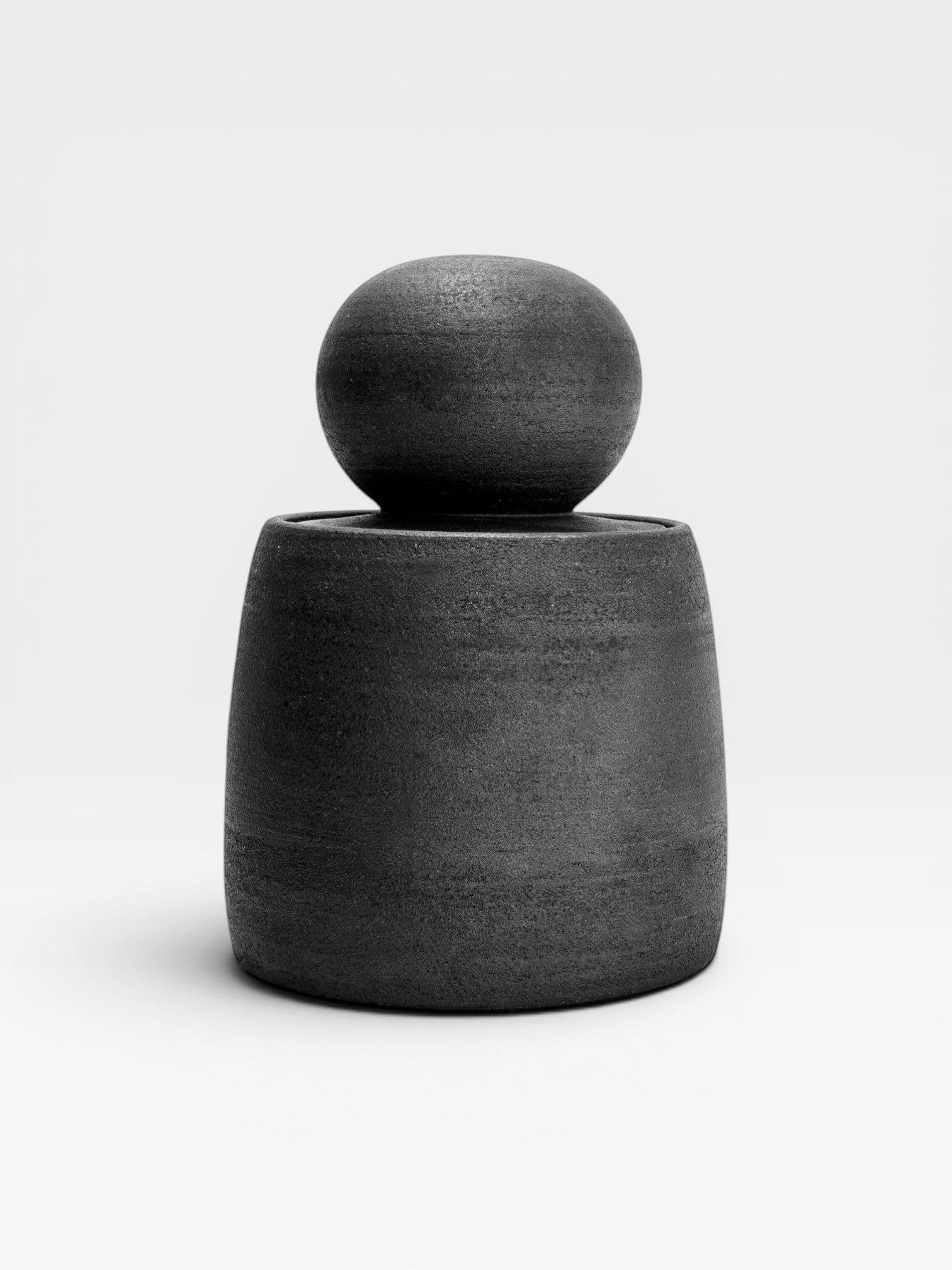 JONES + CO matte charcoal stoneware stash jar with a large chunky knob and glossy black interior. Hand-thrown, unique piece.