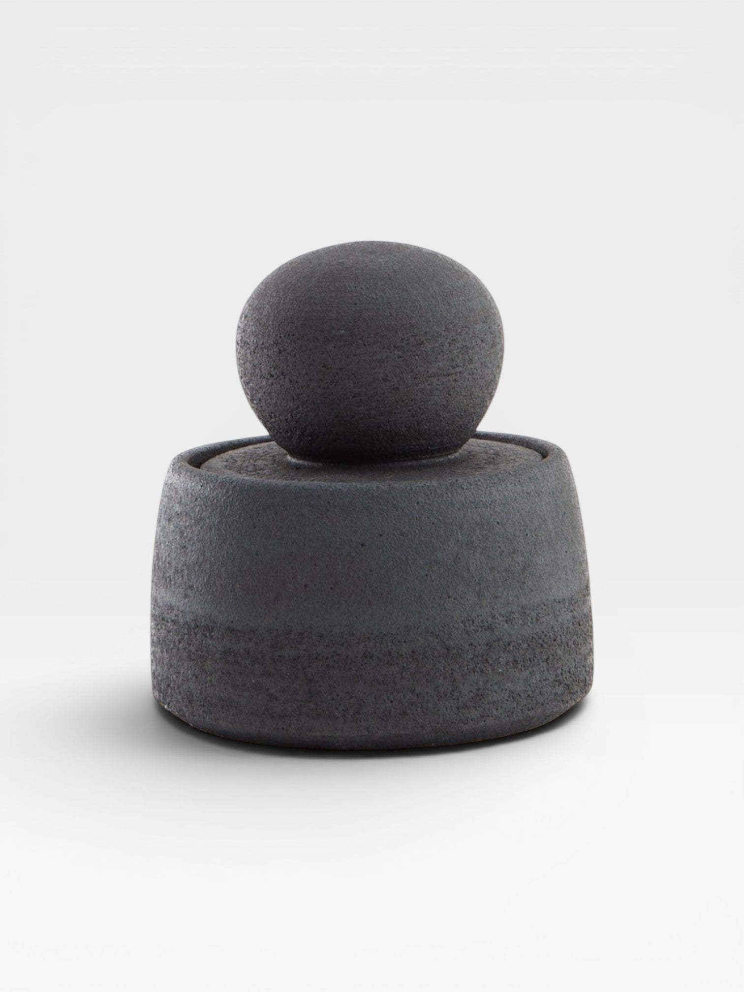 JONES + CO matte charcoal stoneware stash jar with a large chunky knob and glossy black interior. Hand-thrown, unique piece.