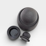 JONES + CO matte charcoal stoneware stash jar with chunky knob lid and glossy black interior. Hand-thrown ceramic.