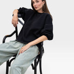 JONES + CO charcoal grey crewneck sweatshirt with drop shoulders, raw hem, and distressed details.