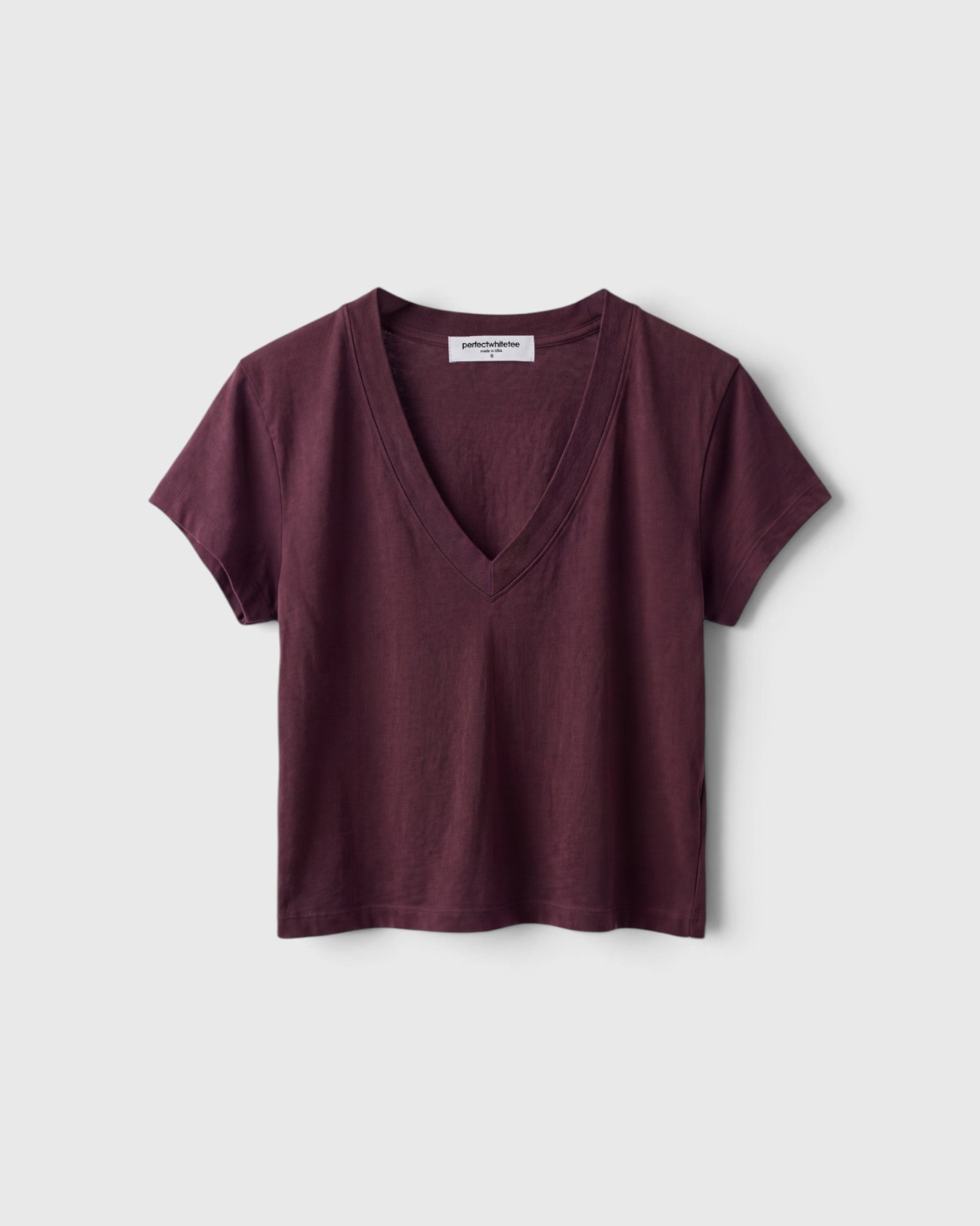 JONES + CO Alanis V neck tee in cherry lacquer recycled cotton with a relaxed cropped fit and deep neckline.