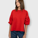 JONES + CO Rachel Comey cherry red crewneck sweatshirt with drop shoulders and raw edge hem worn by a model