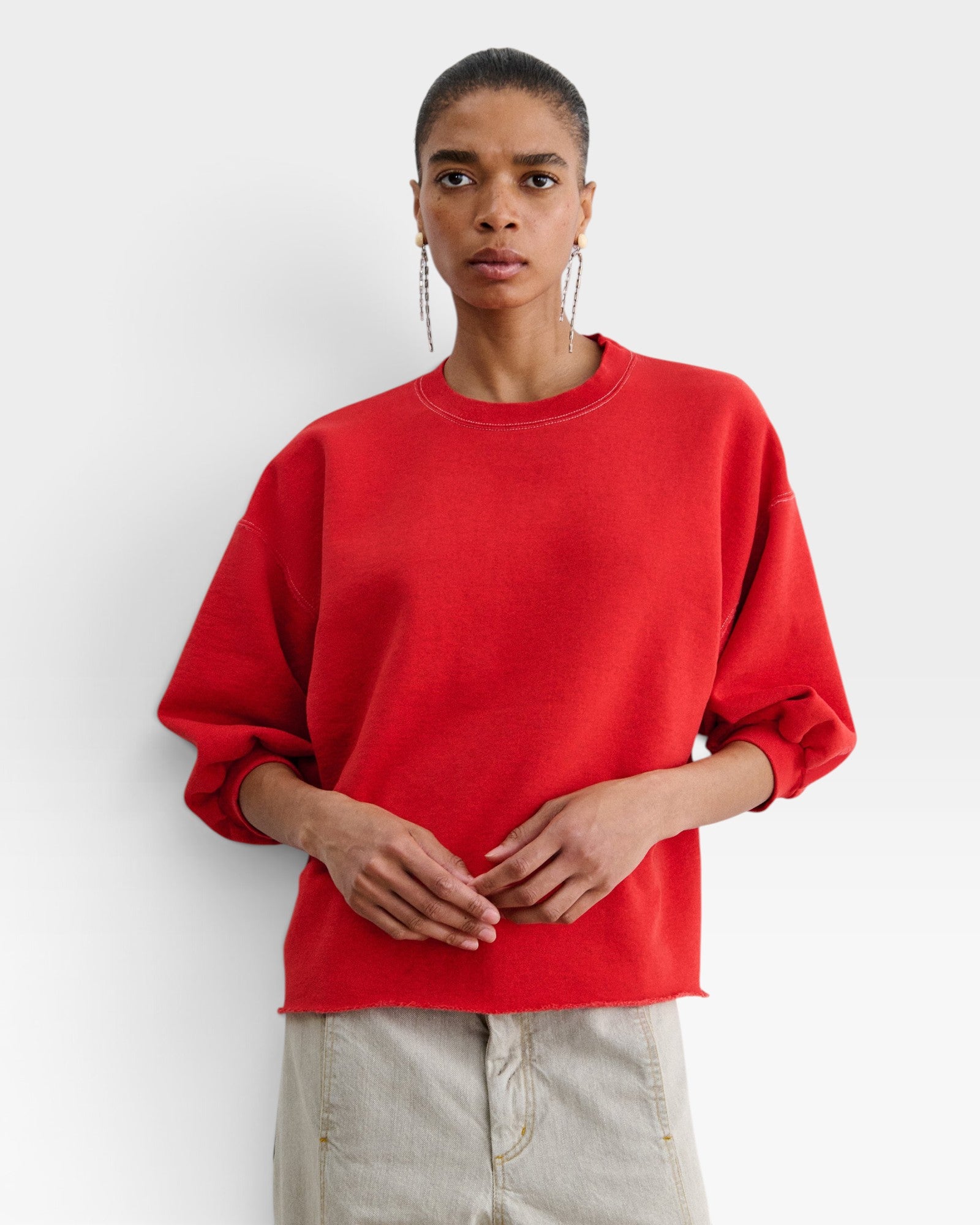 JONES + CO Rachel Comey Fond crewneck sweatshirt in cherry red with drop shoulders and raw edge hem on a model